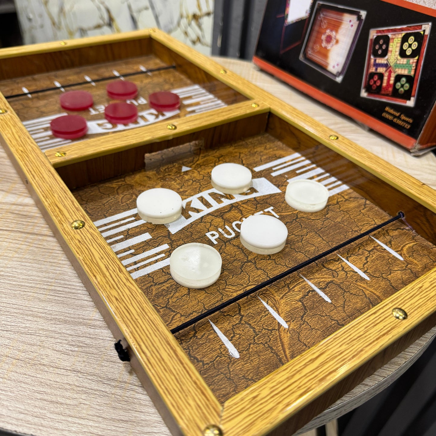 Wooden Pucket Board Game for Kids & Adults | 2 Player Fast Sling Puck Game | 18x10 Inch Family Fun Game | Tabletop Action Game for Parties & Home - Mahal Al MadinahGAMESMahal Al MadinahMahal Al MadinahWooden Pucket Board Game for Kids & Adults | 2 Player Fast Sling Puck Game | 18x10 Inch Family Fun Game | Tabletop Action Game for Parties & HomeWooden Pucket Board Game for Kids & Adults | 2 Player Fast Sling Puck Game | 18x10 Inch Family Fun Game | Tabletop Action Game for Parties & Home